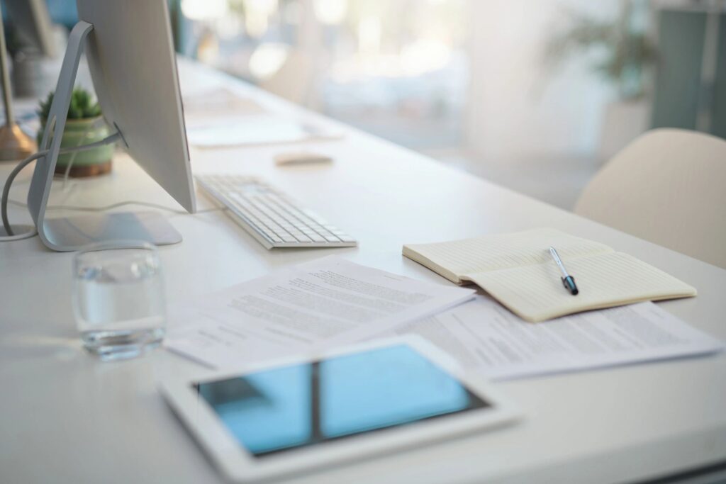 Shot of various items on a desk in an empty modern office